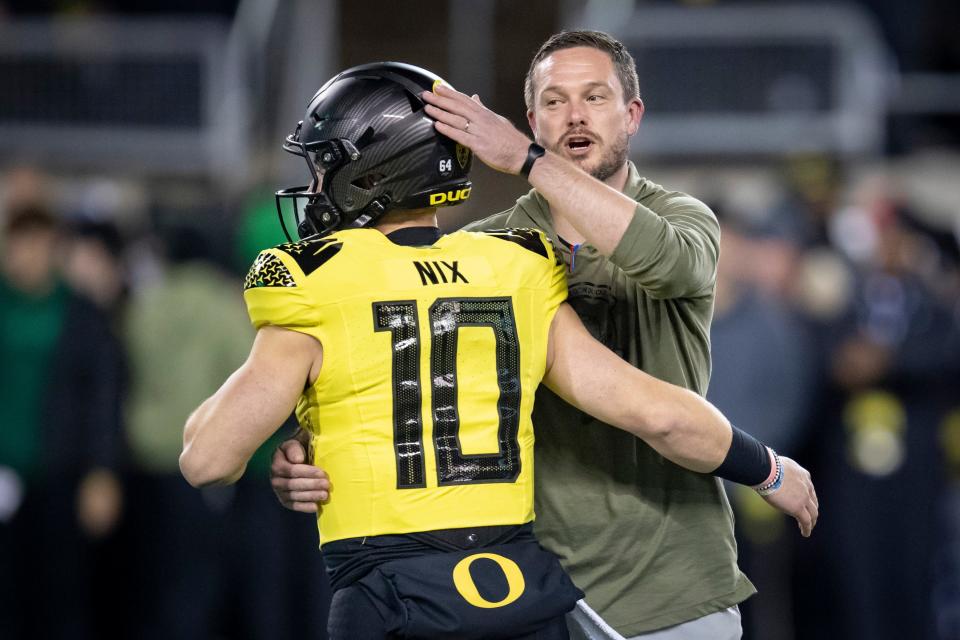 Oregon head coach Dan Lanning greets quarterback Bo Nix before the game Saturday as the No. 6 Oregon Ducks host the USC Trojans.