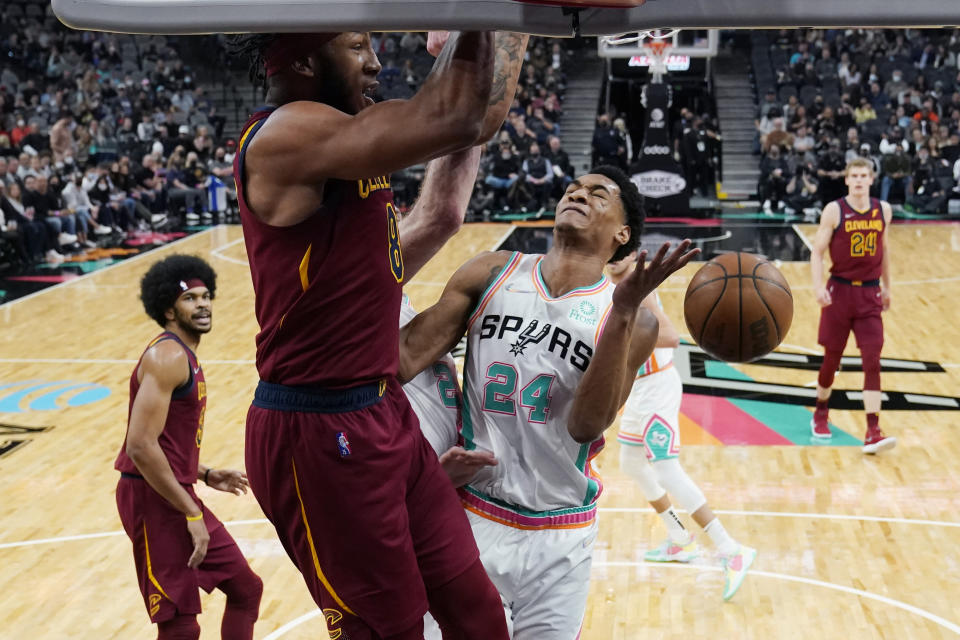 Cleveland Cavaliers forward Lamar Stevens (8) scores over San Antonio Spurs guard Devin Vassell (24) during the first half of an NBA basketball game, Friday, Jan. 14, 2022, in San Antonio. (AP Photo/Eric Gay)