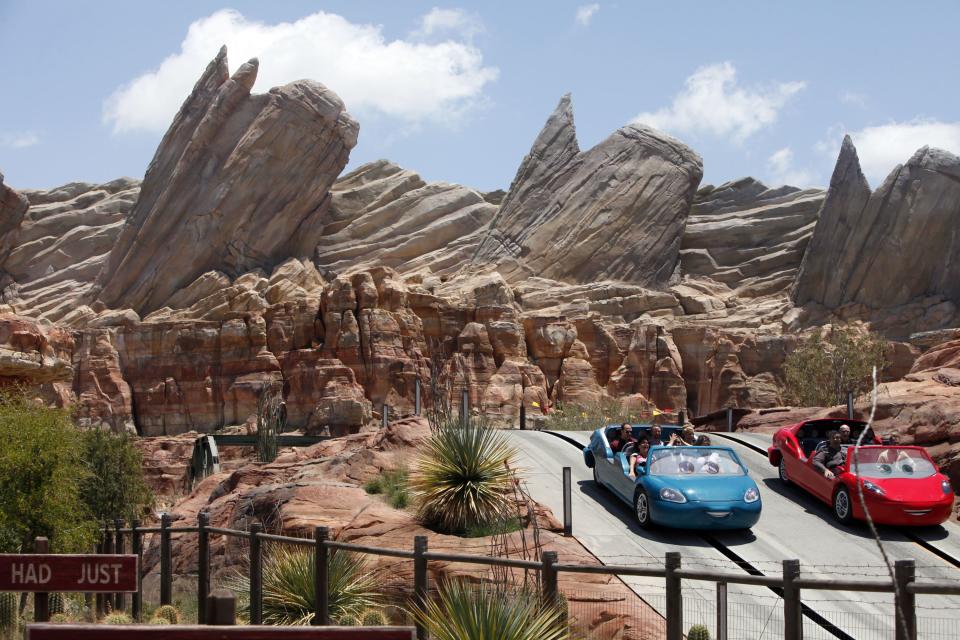 This June 5, 2012 photo shows riders on the new Car Land attraction at Disney California Adventure in Anaheim, Calif. The park's five-year, $1 billion-plus revamp has debuted in spurts since 2008. Most of its new features rely on characters that come from Disney's $7.4 billion acquisition of Pixar Animation Studios, the San Francisco-area studio behind "Cars," "Toy Story," "Monsters Inc." and "A Bug's Life." (AP Photo/Nick Ut)