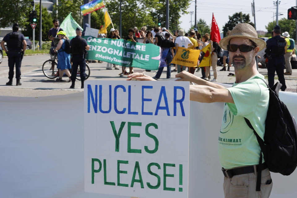 FILE - A pro-nuclear activist demonstrates outside the European Parliament, on July 6, 2022 in Strasbourg, eastern France. Europe is staring an energy crisis in the face. The cause: Russia throttling back supplies of natural gas. European officials say it's a pressure game over their support for Ukraine after Russia's invasion. (AP Photo/Jean-Francois Badias, File)