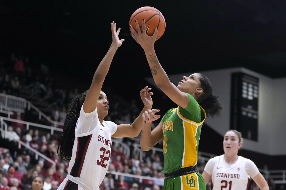 Oregon guard Priscilla Williams (4) drives to the basket against Stanford guard Jzaniya Harriel (32) during the first half of an NCAA college basketball game Friday, Jan. 19, 2024, in Stanford, Calif. (AP Photo/Tony Avelar)
