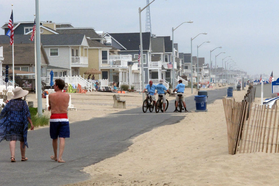 This June 17, 2019 photo, shows the beach walk in Manasquan, N.J., which did not rebuild its protective sand dunes after Superstorm Sandy in 2012. The U.S. Army Corps of Engineers will review whether the handful of places along the New Jersey shore that don't have dunes now should build them. (AP Photo/Wayne Parry)
