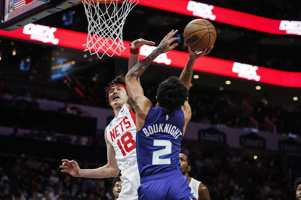 Brooklyn Nets forward Yuta Watanabe (18) attempts to block the shot of Charlotte Hornets guard James Bouknight (2) during the first half of an NBA basketball game, Saturday, Nov. 5, 2022, in Charlotte, N.C. (AP Photo/Rusty Jones)