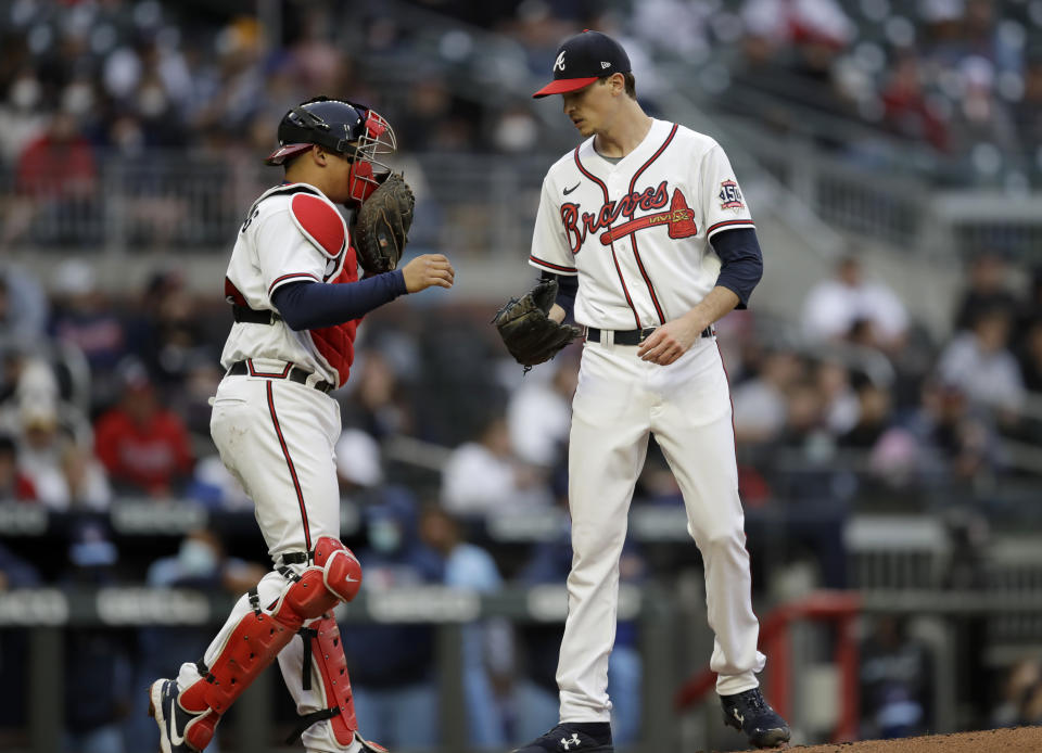 Atlanta Braves pitcher Max Fried, right, speaks with catcher William Contreras during the first inning of the team's baseball game against the Toronto Blue Jays on Wednesday, May 12, 2021, in Atlanta. (AP Photo/Ben Margot)