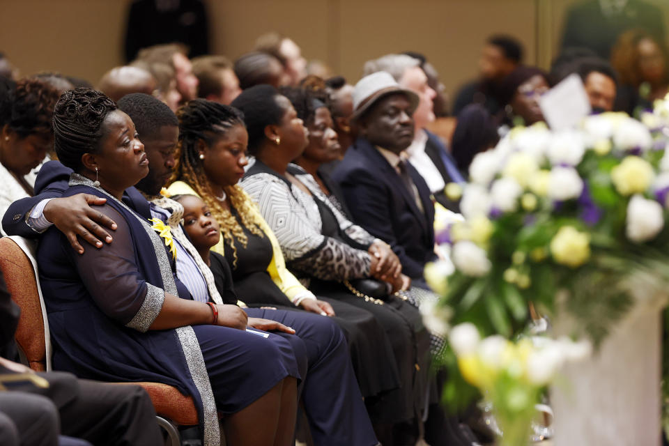 Caroline Ouko, left, and Leon Ochieng, second from left, mother and older brother of Irvo Otieno, sit with family and friends during the celebration of life for Otieno at First Baptist Church in North Chesterfield, Va., on Wednesday, March 29, 2023. Irvo Otieno, a 28-year-old Black man, died after he was pinned to the floor by seven sheriff's deputies and several others while he was being admitted to a mental hospital. (Eva Russo/Richmond Times-Dispatch via AP)