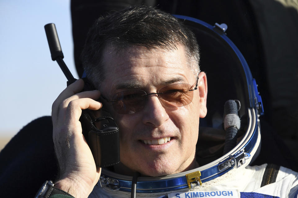 Astronaut Robert Shane Kimbrough uses a sat phone