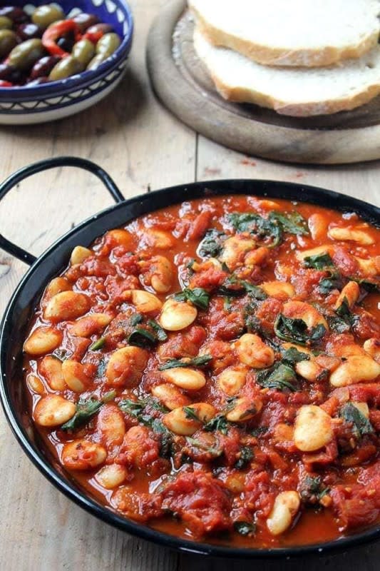 <p>Veggie Desserts</p><p>These Spanish beans with tomatoes and smokey sweet spices are so easy to prepare. You can make them in one pot in less than 20 minutes with just 7 pantry ingredients, including canned beans and tomatoes. If you don’t have fresh spinach, just use frozen.</p><p><strong>Get the Recipe: <a href="https://veggiedesserts.com/spanish-beans-tomatoes/" rel="nofollow noopener" target="_blank" data-ylk="slk:Spanish Beans with Tomatoes;elm:context_link;itc:0;sec:content-canvas" class="link rapid-noclick-resp">Spanish Beans with Tomatoes</a></strong></p>