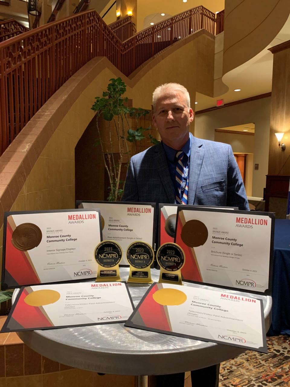 Joe Verkennes, Monroe County Community College's director of marketing and communications, is shown with the college's Medallion Awards, received at the recent National Council for Marketing and Public Relations District 3 and 5 Conference in St. Louis, Mo.