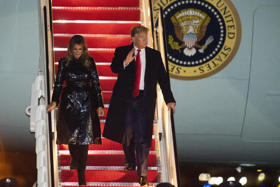 President Donald Trump and first lady Melania Trump exit Air Force One early Tuesday, Jan. 14, 2020, at Andrews Air Force Base, Md., after attending the College Football National Championship game in New Orleans. (AP Photo/Kevin Wolf)