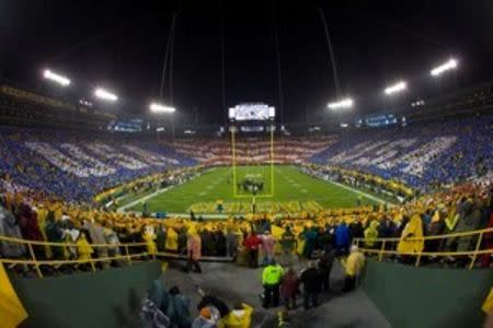 General view of Lambeau Field as fans hold up signs during a card stunt during the national anthem prior to the NFL game between the Chicago Bears and Green Bay Packers on Thanksgiving. Jeff Hanisch-USA TODAY Sports