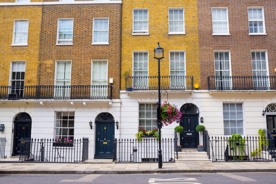 Facade of Georgian residential town houses made in yellow and red brick in a luxury residential area of West London.