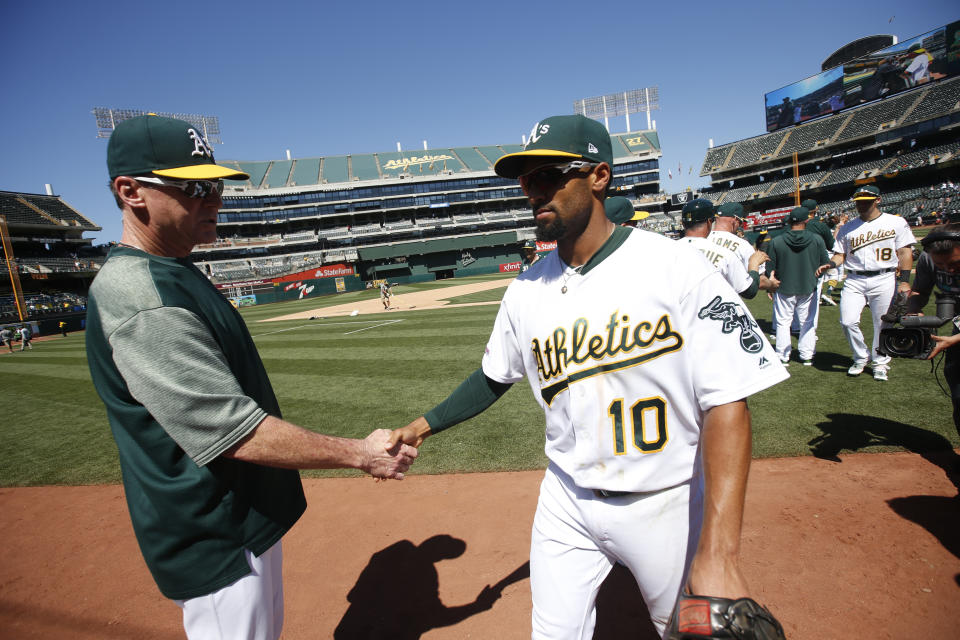 OAKLAND, CA - JUNE 19: Manager Bob Melvin #6 of the Oakland Athletics celebrates with Marcus Semien #10 on the field following the game against the Baltimore Orioles at the Oakland-Alameda County Coliseum on June 19, 2019 in Oakland, California. The Athletics defeated the Orioles 8-3. (Photo by Michael Zagaris/Oakland Athletics/Getty Images)