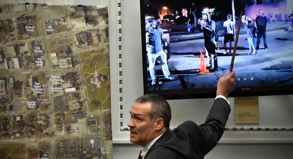 Mark Richards, Kyle Rittenhouse's lead attorney, points to people in a video taken the night of Aug. 25, 2020, as he cross-examines Kenosha Police Department Detective Martin Howard on Wednesday.