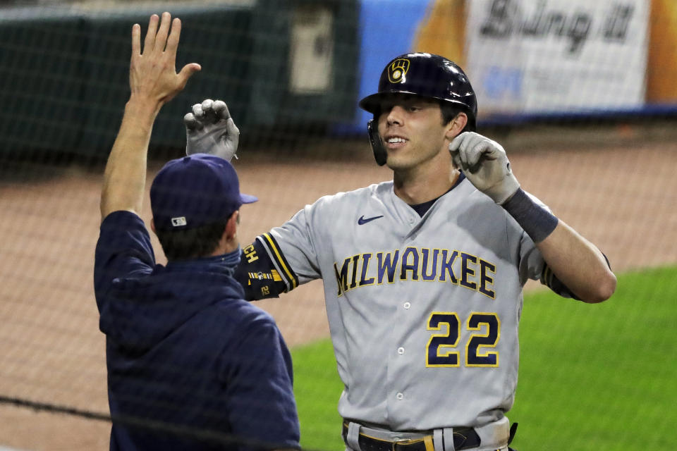 FILE - In this Thursday, Aug. 6, 2020, file photo, Milwaukee Brewers' Christian Yelich, right, celebrates with manager Craig Counsell after hitting an inside-the-park home run against the Chicago White Sox during the fifth inning of a baseball game in Chicago. Counsell is confident former MVP Yelich’s 2020 hitting struggles won’t carry over into next season. (AP Photo/Nam Y. Huh, File)