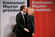 FILE PHOTO: Emmanuel Macron, head of the political movement 'En Marche!', or 'Onwards!', and candidate for the 2017 presidential election, kisses his wife Brigitte Trogneux, as they attend a meeting for Women's Day in Paris, France, March 8, 2017. REUTERS/Gonzalo Fuentes/File Photo