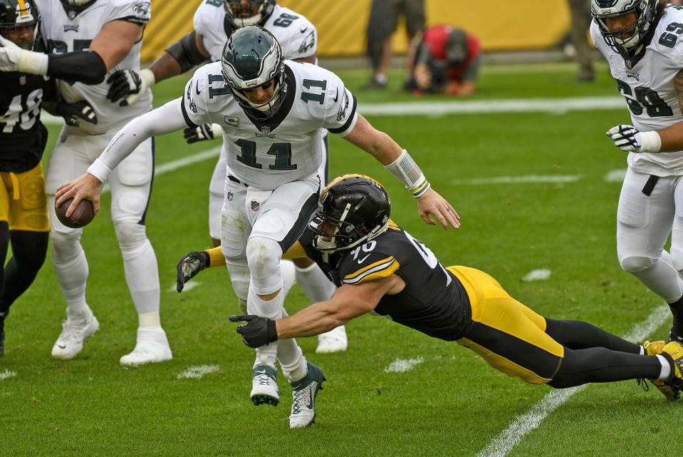 Philadelphia Eagles quarterback Carson Wentz (11) is sacked by Pittsburgh Steelers outside linebacker T.J. Watt (90) during the first half of an NFL football game in Pittsburgh, Sunday, Oct. 11, 2020. (AP Photo/Don Wright)