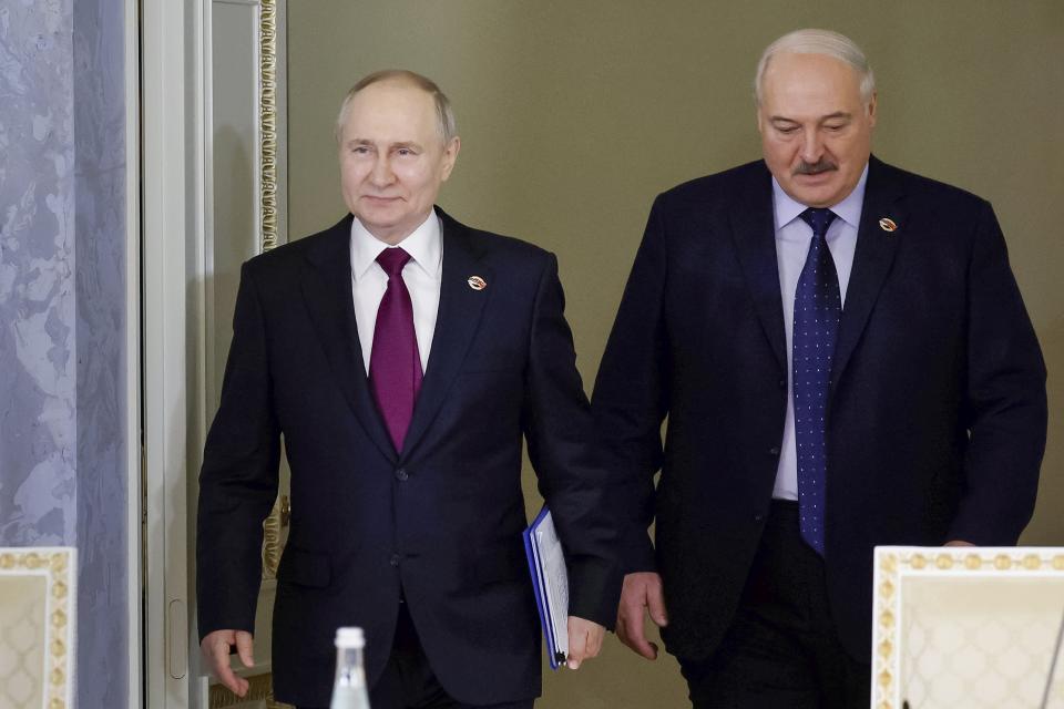 Russian President Vladimir Putin, left, and Belarus President Alexander Lukashenko arrive to attend a meeting of the Union State Supreme Council in St. Petersburg, Russia, Monday, Jan. 29, 2024. (Dmitry Astakhov, Sputnik, Government Pool Photo via AP)