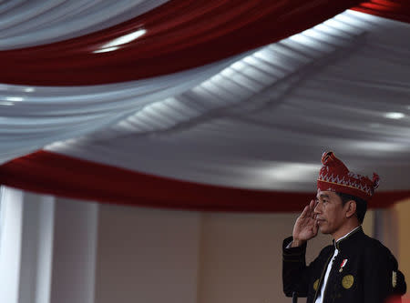 Indonesia President Joko Widodo salutes during a ceremony to mark Independence Day at the Presidential Palace in Jakarta, Indonesia August 17, 2017 in this photo taken by Antara Foto. Picture taken August 17, 2017. Antara Foto/Puspa Perwitasari/ via REUTERS