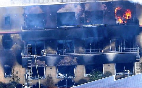 It was reported that the suspect had poured a gasoline-like substance around the building and said "drop dead" - Credit: Asahi Shimbun