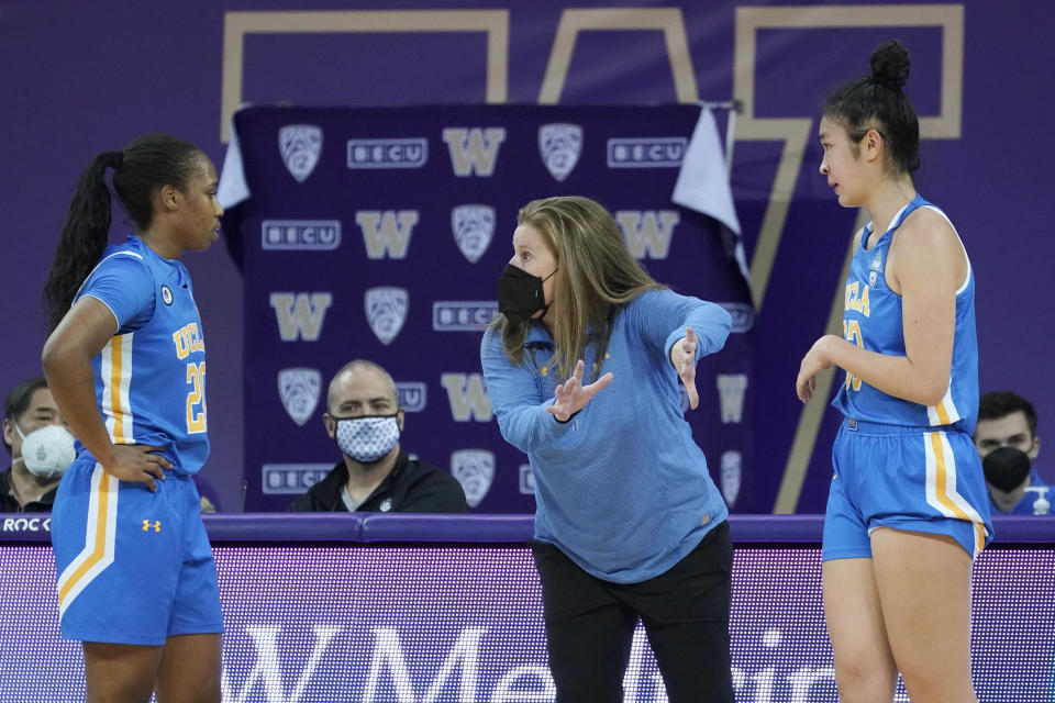 UCLA head coach Cori Close, center, talks with guard Charisma Osborne, left, and guard Natalie Chou, right, during the second half of an NCAA college basketball game against Washington, Sunday, Feb. 7, 2021, in Seattle. (AP Photo/Ted S. Warren)