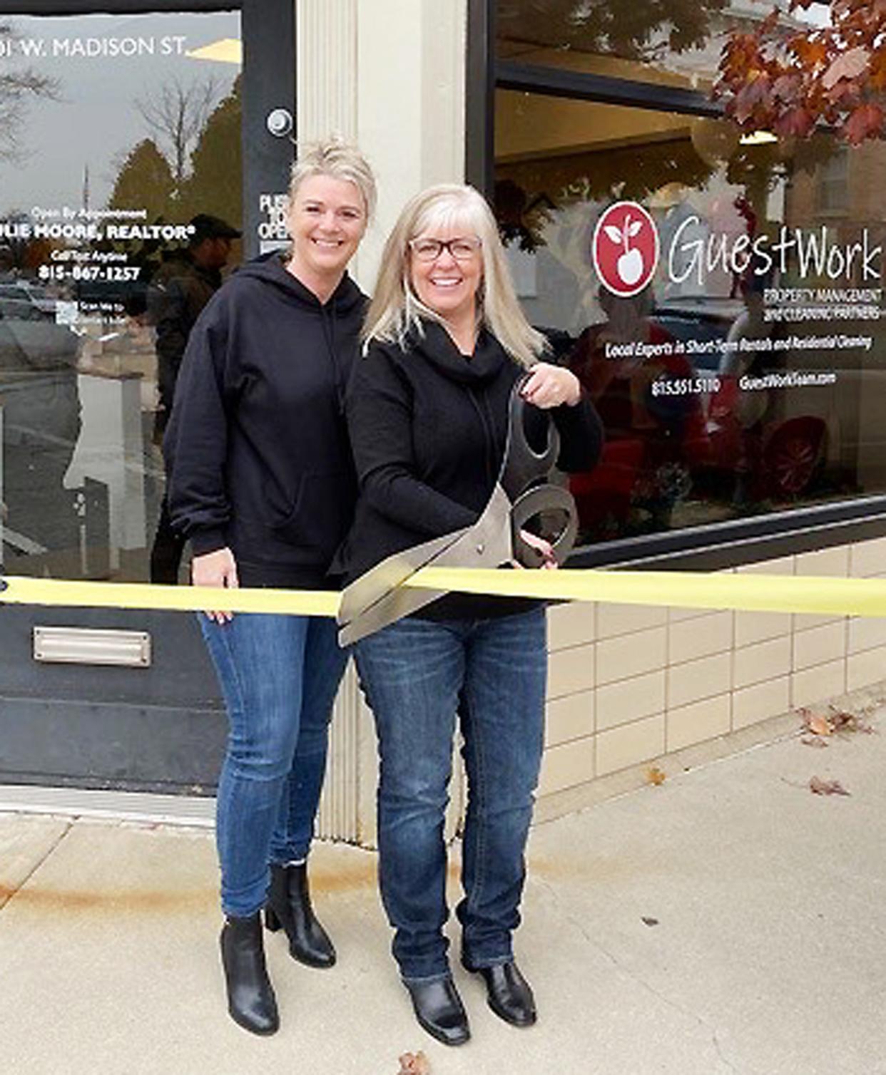 Aubrey Graves and Julie Moore of the Vision Homes Group, RE/MAX Rising Team pose before cutting a ribbon to their new business at 201 W. Madison St.