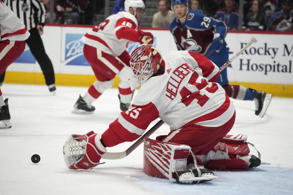 Detroit Red Wings goaltender Magnus Hellberg (45) makes a glove-save against the Colorado Avalanche in the third period of an NHL hockey game Monday, Jan. 16, 2023, in Denver. (AP Photo/David Zalubowski)