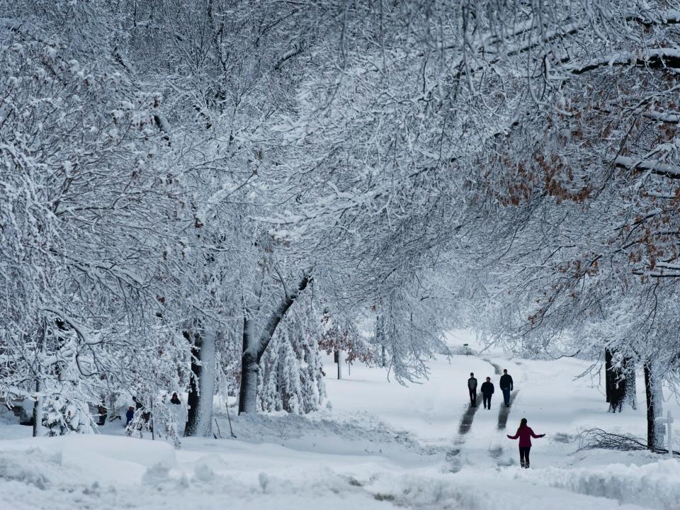 Pedestrians walk down snow-swept streets in Kansas.