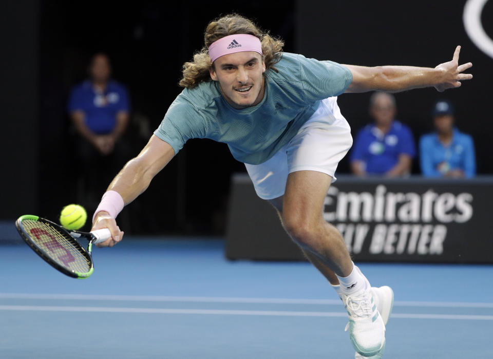 Greece's Stefanos Tsitsipas makes a forehand return to Switzerland's Roger Federer during their fourth round match at the Australian Open tennis championships in Melbourne, Australia, Sunday, Jan. 20, 2019. (AP Photo/Mark Schiefelbein)