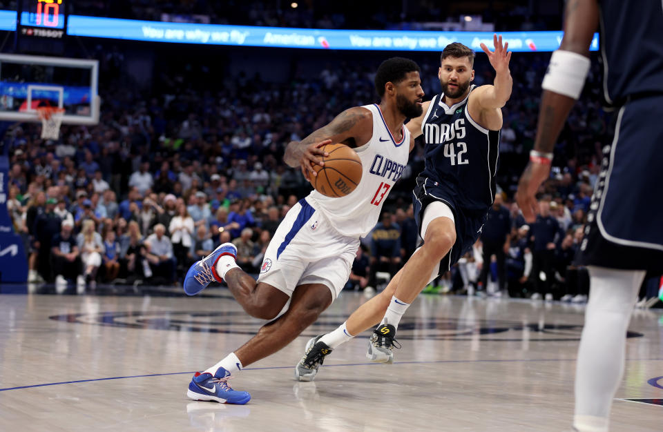 DALLAS, TEXAS - APRIL 28: Paul George #13 of the Los Angeles Clippers drives to the basket while defended by Maxi Kleber #42 of the Dallas Mavericks in the second half of game four of the Western Conference First Round Playoffs at American Airlines Center on April 28, 2024 in Dallas, Texas.  NOTE TO USER: User expressly acknowledges and agrees that, by downloading and or using this photograph, User is consenting to the terms and conditions of the Getty Images License Agreement. (Photo by Tim Warner/Getty Images)