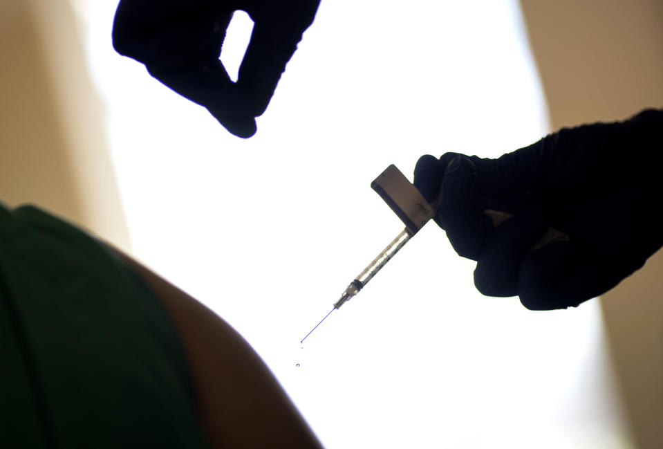 FILE - In this Dec. 15, 2020, file photo, a droplet falls from a syringe after a health care worker was injected with the Pfizer-BioNTech COVID-19 vaccine at Women & Infants Hospital in Providence, R.I. The first COVID-19 vaccinations are underway at U.S. nursing homes, where the virus has killed upwards of 110,000 people, even as the nation struggles to contain a surge so alarming that California is dispensing thousands of body bags and lining up refrigerated morgue trailers. (AP Photo/David Goldman, File)