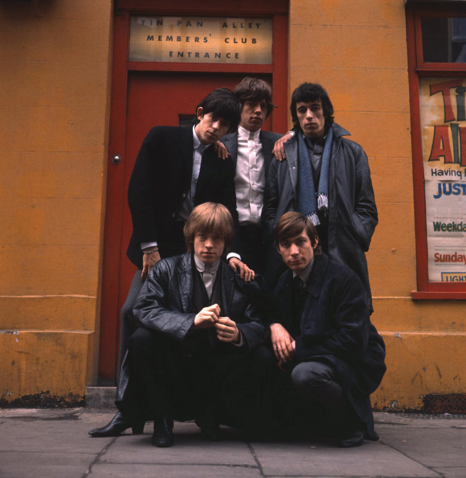 The Rolling Stones pose outside the Tin Pan Alley Club in London, early 1964. Clockwise from top left, Keith Richards, Mick Jagger, Bill Wyman, Charlie Watts and Brian Jones (1942 - 1969). (Photo by Terry O'Neill/Hulton Archive/Getty Images) 