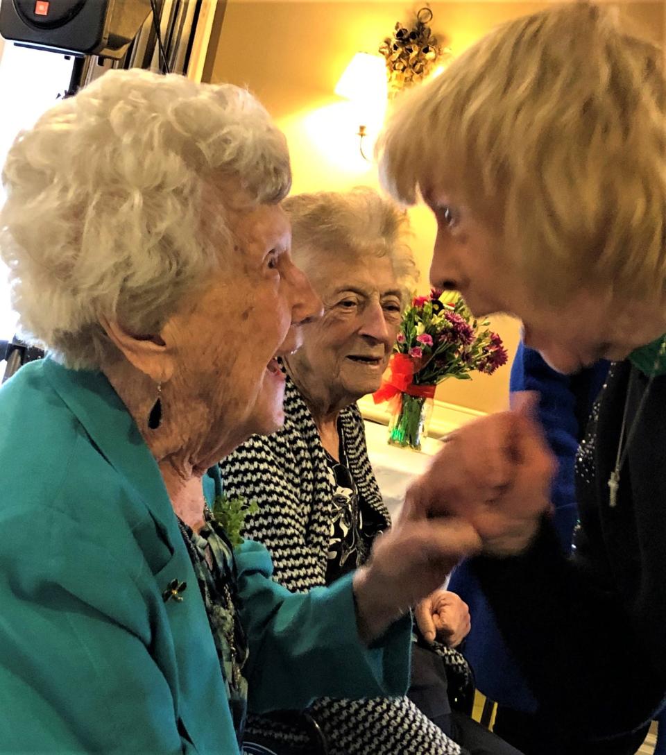 Mary McCarthy Warren, left, shared her joy in seeing friends and family on her 100th birthday party March 18 at The Common Market in Quincy. In the background is Ann Lydon, of Hingham.