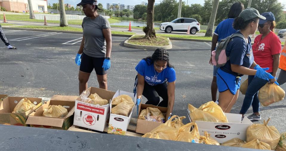 Volunteers prepare food for distribution on Saturday, June 22, 2024 at the University Preparatory Academy in West Palm Beach. The Urban League of Palm Beach County held its third annual Summer Food Drive at three locations in the county.