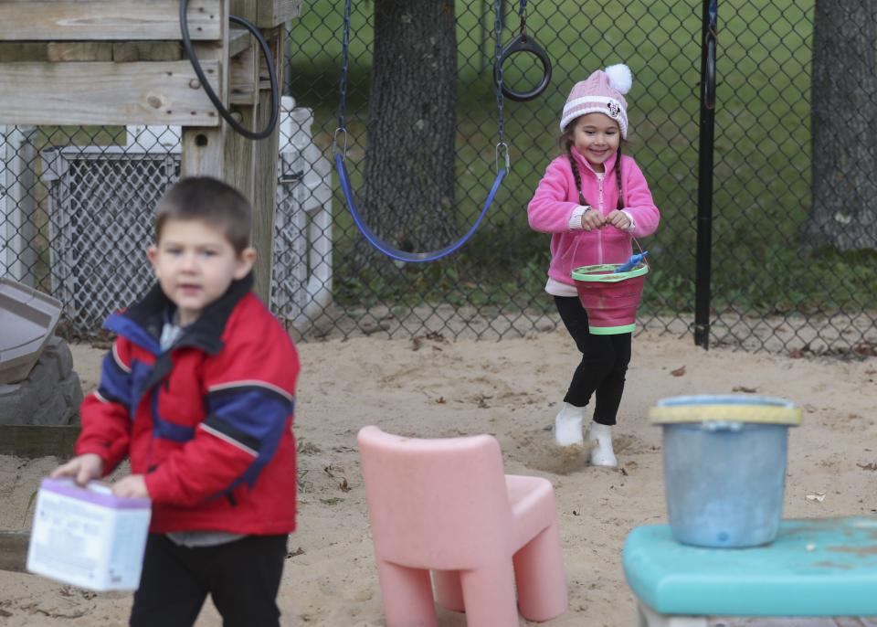 Paisley Conkey carries a bucket of sand on Oct. 5 at Little Racecar Daycare in Wisconsin Rapids. Jeannie Arndt paid for fencing with funding received through a grant program that helps people in nine counties meet the requirements to become regulated child-care providers.