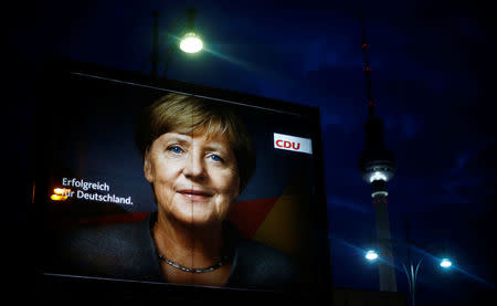 An election campaign poster for the upcoming general elections of the Christian Democratic Union party (CDU) with a headshot of German Chancellor Angela Merkel is displayed at Alexanderplatz square in Berlin, Germany, September 21, 2017. REUTERS/Hannibal Hanschke