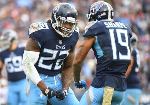 Tennessee Titans running back Derrick Henry (22) celebrates with wide receiver Tajae Sharpe (19) after a touchdown during the second half against the New England Patriots at Nissan Stadium - Credit: Christopher Hanewinckel/USA Today