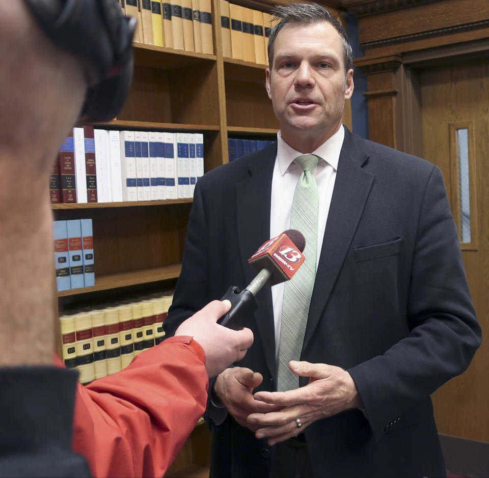 FILE - In this Nov. 30, 2018 file photo, then Kansas Secretary of State Kris Kobach responds to questions from reporters in Topeka, Kan. Schmidt announced Tuesday, June 2, 2020, that he will appeal a 10th U.S. Circuit Court of Appeals decision in April that said the state could not enforce a proof-of-citizenship law. An appeals-court panel said the law violated the U.S. Constitution's guarantee of equal legal protection as well as a federal voter registration law.(AP Photo/John Hanna, File)