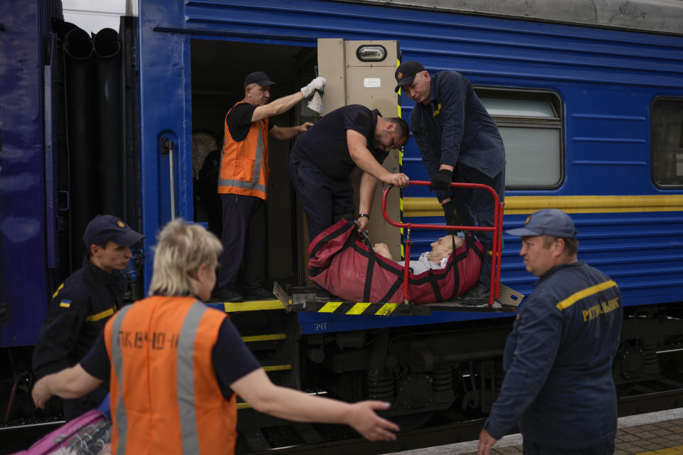 A man fleeing from shelling boards an evacuation train in a soft stretcher at the train station in Pokrovsk, eastern Ukraine, eastern Ukraine, Saturday, May 28, 2022. Fighting has raged around Lysychansk and neighbouring Sievierodonetsk, the last major cities under Ukrainian control in Luhansk region. (AP Photo/Francisco Seco)
