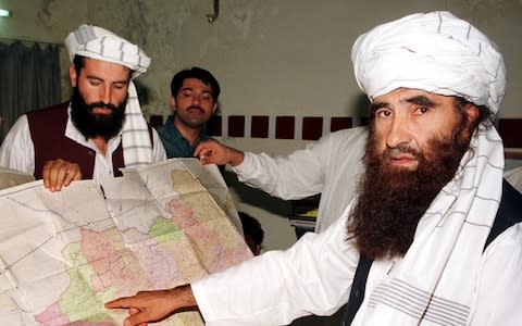 Jalaluddin Haqqani, the Taliban's Minister for Tribal Affairs, points to a map of Afghanistan during a visit to Islamabad, Pakistan - Credit: Reuters