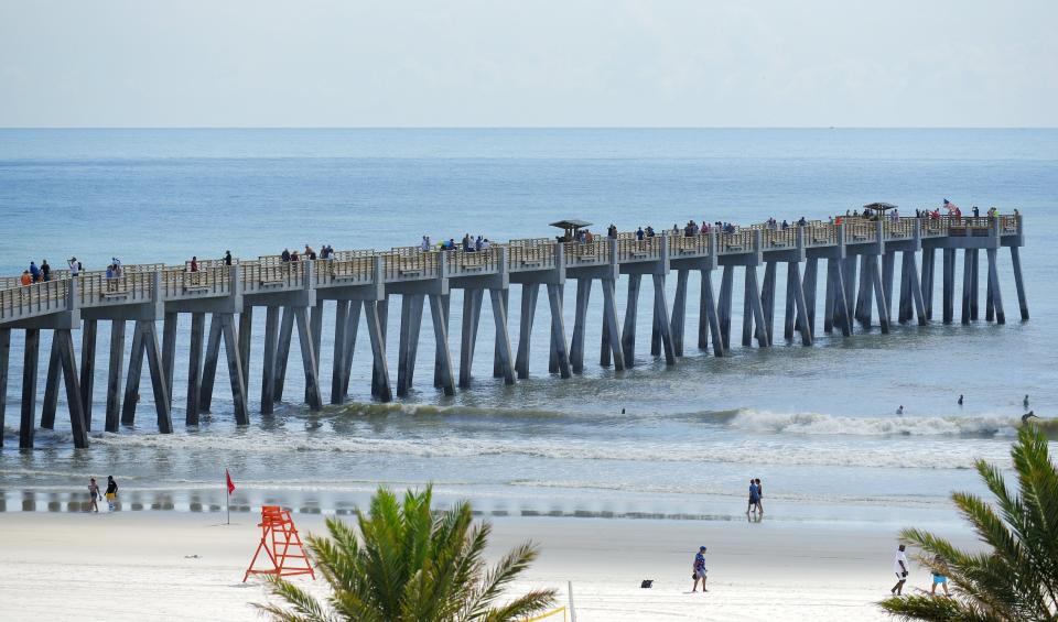 Visitors walk the Jacksonville Beach Pier for the first time since it was closed in 2019 after the formal ribbon-cutting ceremony Wednesday morning. The pier is now open during the day for pedestrians but will not be open for fishing for another two weeks.