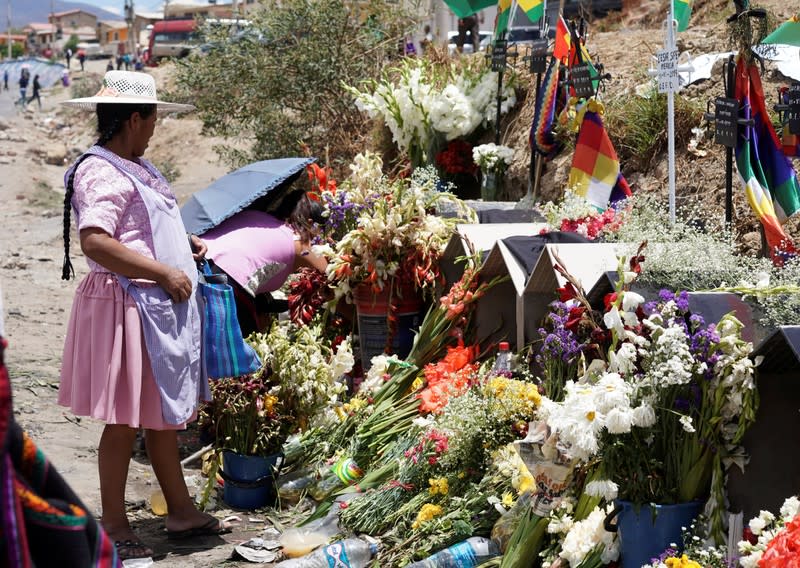 Coca growers who support Bolivia's ousted President Evo Morales leave flowers in the graves of demonstrators dead during clashes, in Sacaba