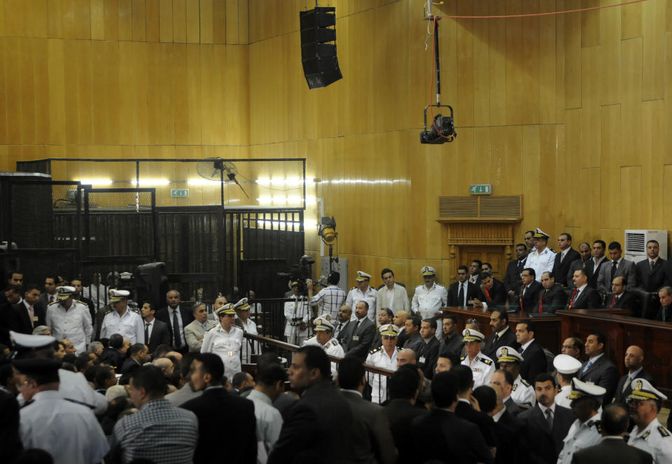 FILE - In this Saturday, June 2, 2012 file photo, people gather inside a courtroom to hear a verdict in the trial of former Egyptian President Hosni Mubarak, his sons and several security officers in Cairo, Egypt, Saturday, June 2, 2012. A verdict sentencing more than 520 people to death on Monday, March 24, 2014 after a cursory mass trial has drawn new attention on Egypt’s judiciary, where many judges are strong backers of the military and sharp opponents of Islamists, operating amid a media frenzy calling for swift and harsh verdicts against the Muslim Brotherhood.(AP Photo, File)