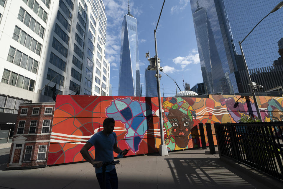 Behind a colorful mural the Port Authority police have a temporary facility at the World Trade Center, Wednesday, Sept. 8, 2021 in New York. A partnership led by Brookfield Properties and Silverstein Properties will develop the site as a 900-foot (270-meter) tower with office and retail space in addition to 1,325 apartments. Two decades after its destruction in the Sept. 11 terrorist attacks, the work to rebuild the World Trade Center complex remains incomplete. (AP Photo/Mark Lennihan)