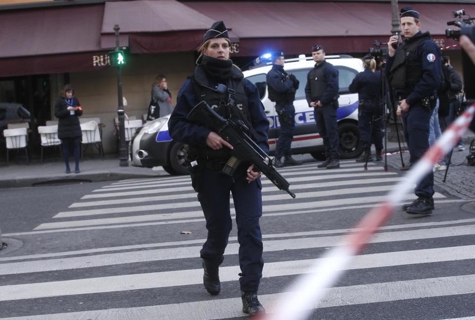 Police officers take position outside the Louvre museum in Paris,Friday, Feb. 3, 2017. Paris police say a soldier has opened fire outside the Louvre Museum after he was attacked by someone, and the area is being evacuated. (AP Photo/Thibault Camus)