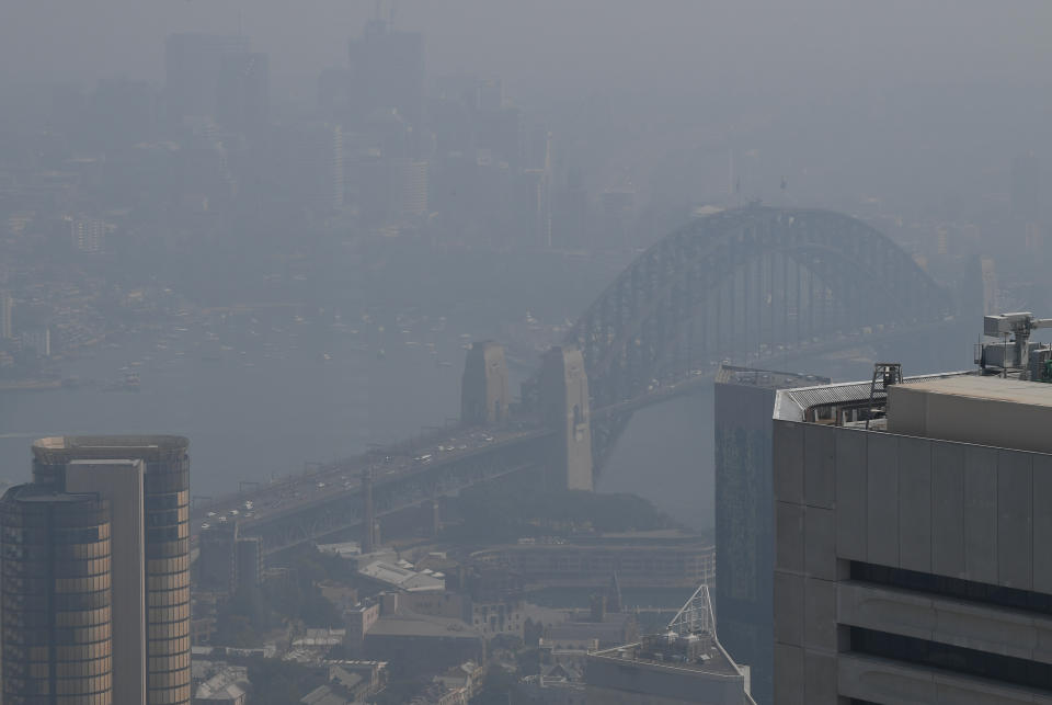 The Sydney Harbour Bridge can be seen through a thick blanket of smoke hanging over Sydney's central business district as seen from The Sydney Tower Eye.