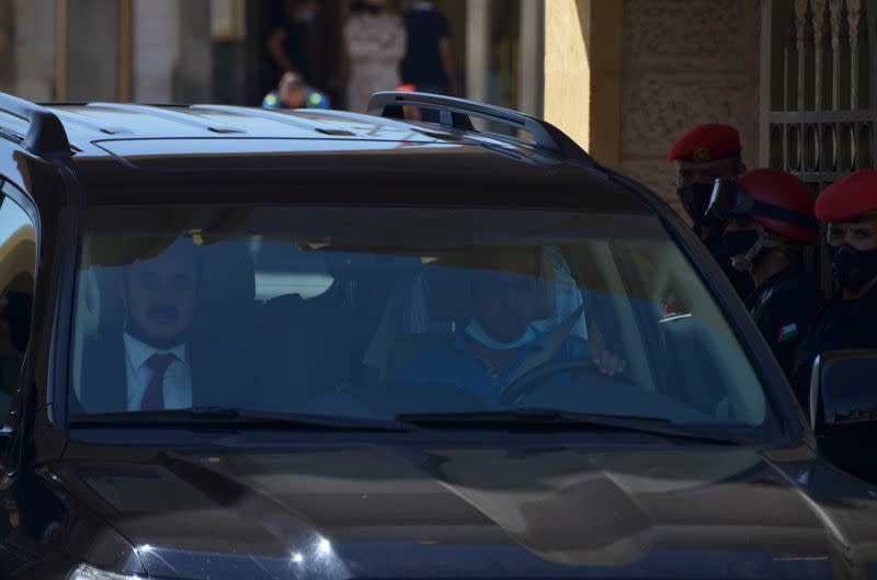 Mohamed Afif, the lawyer of former royal court chief Bassem Awadallah, rides in a vehicle as he leaves a military court in Amman