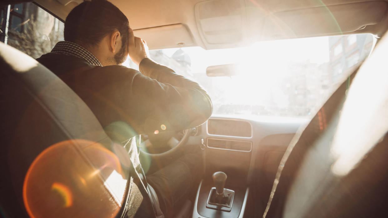 Young man getting frustrated during car drive.