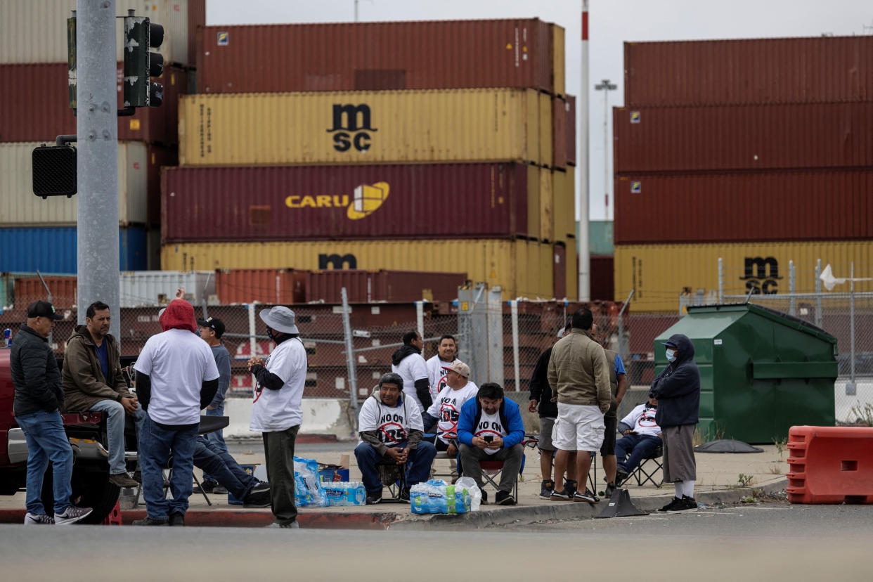 Truck drivers gather to block the entrance of trucks at a container terminal at the Port of Oakland, during a protest against AB5 in Oakland, California, July 21, 2022. REUTERS/Carlos Barria