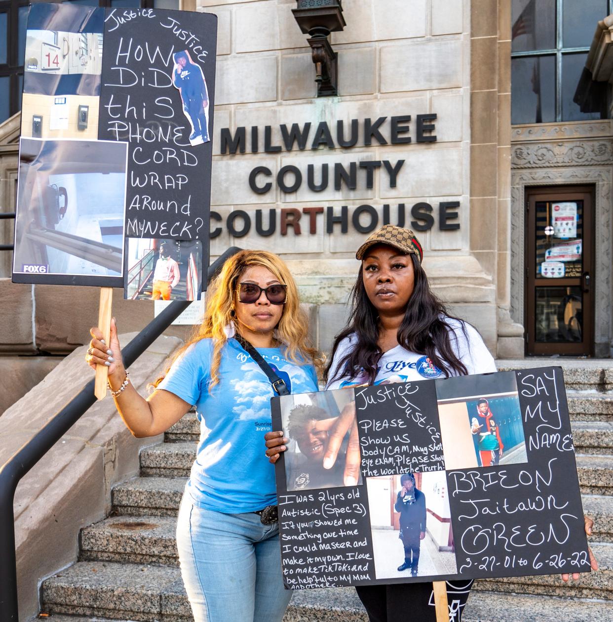 Monique Brewer, left, aunt of Brieon Green, and Laquita Dunlap, his mother, hold signs at a rally to find the truth about his death at the Milwaukee County Jail.