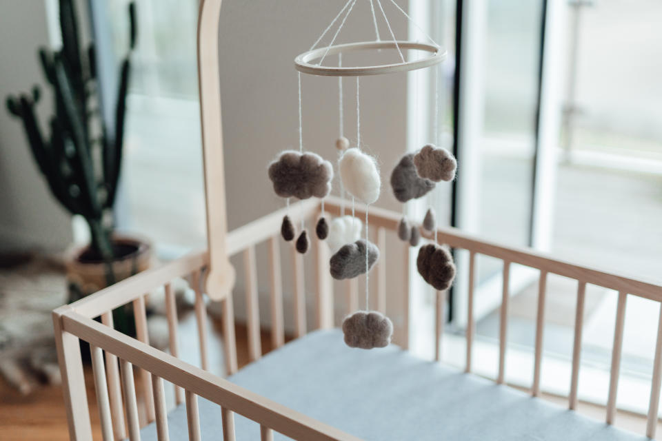 A mobile hangs over a crib. (Oscar Wong / Getty Images)